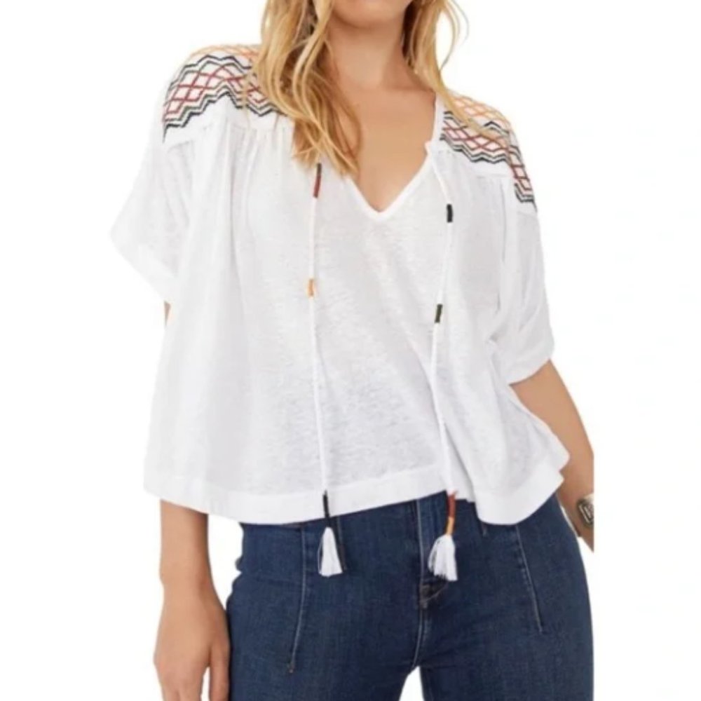 NWT. Free People Boho v-neck top with shoulder stitching and tassels. Size XS.